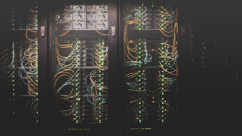 Server room with rows of network equipment and blinking LED lights